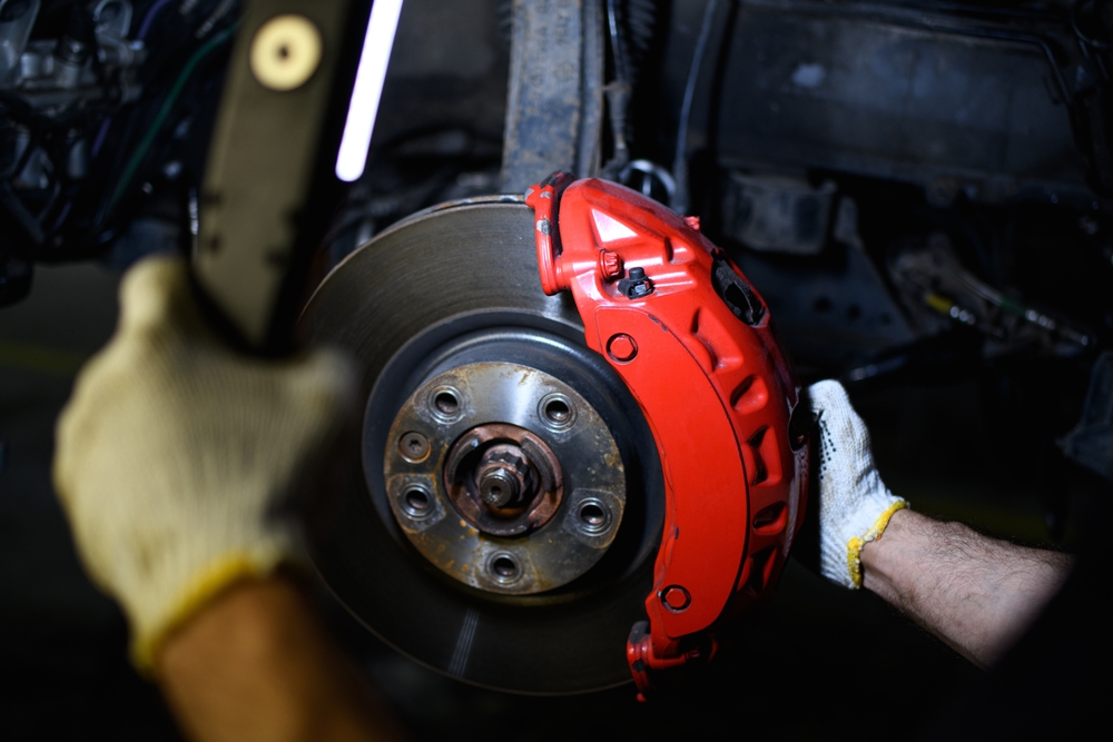 Partial,View,Of,Repairman,In,Gloves,Holding,Lamp,Near,Car